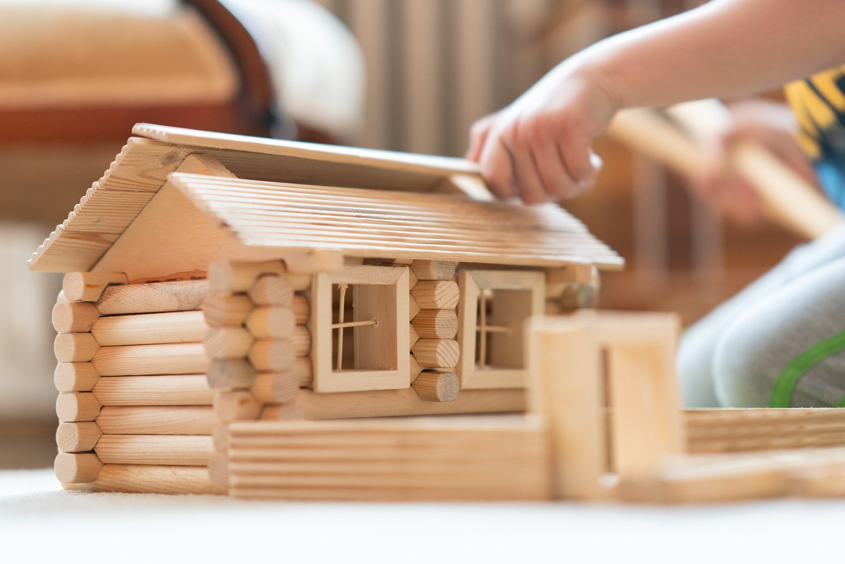 Kids building toy wooden house